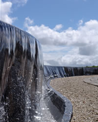 Various seasonal flowers bloom along the side of the approach to the Holy Sanctuary.